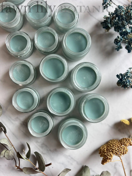 Blue Tansy Shea Butter Facial Balm by Fawn Lily Botanica, a light blue vegan beauty balm in a glass jar, 2 sizes